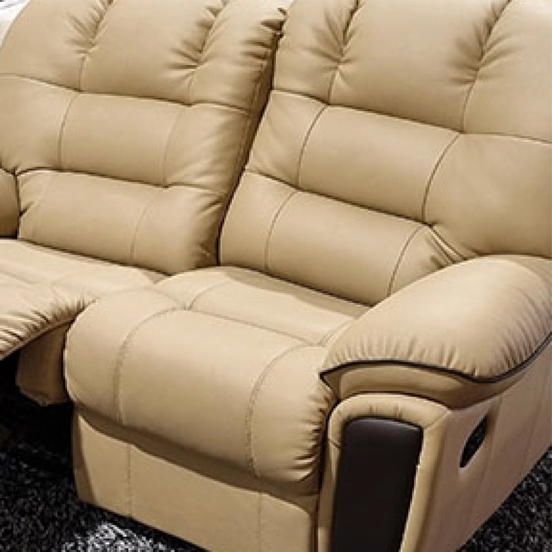Beige recliner sofa on a dark textured floor