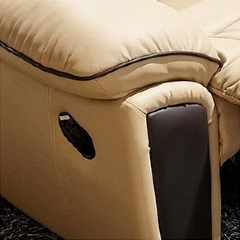 Close-up of a beige upholstered chair with a black trim on a dark surface
