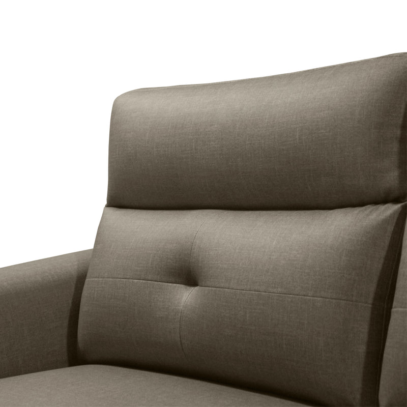 Close-up of a gray upholstered chair with tufted details