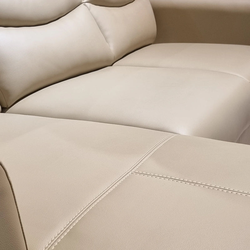 Close-up of a beige leather sofa with stitching details