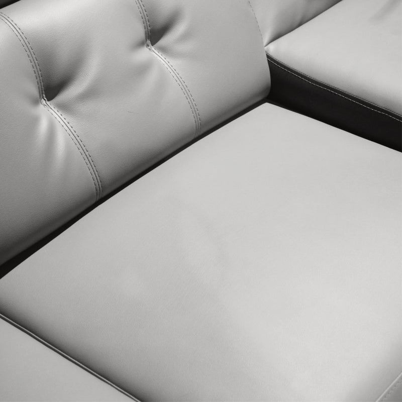 Gray leather sectional sofa with tufted backrest