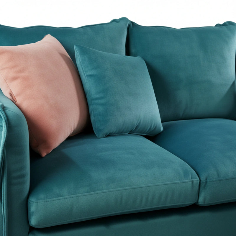 Teal sofa with decorative pillows in a living room setting