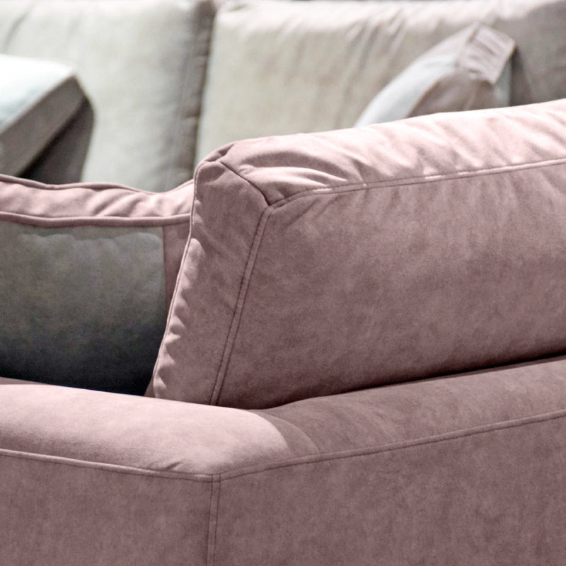 Close-up of a pink sofa with a focus on texture and color.