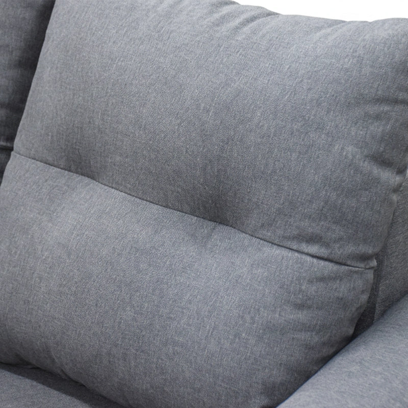 Close-up of a gray fabric sofa with cushions