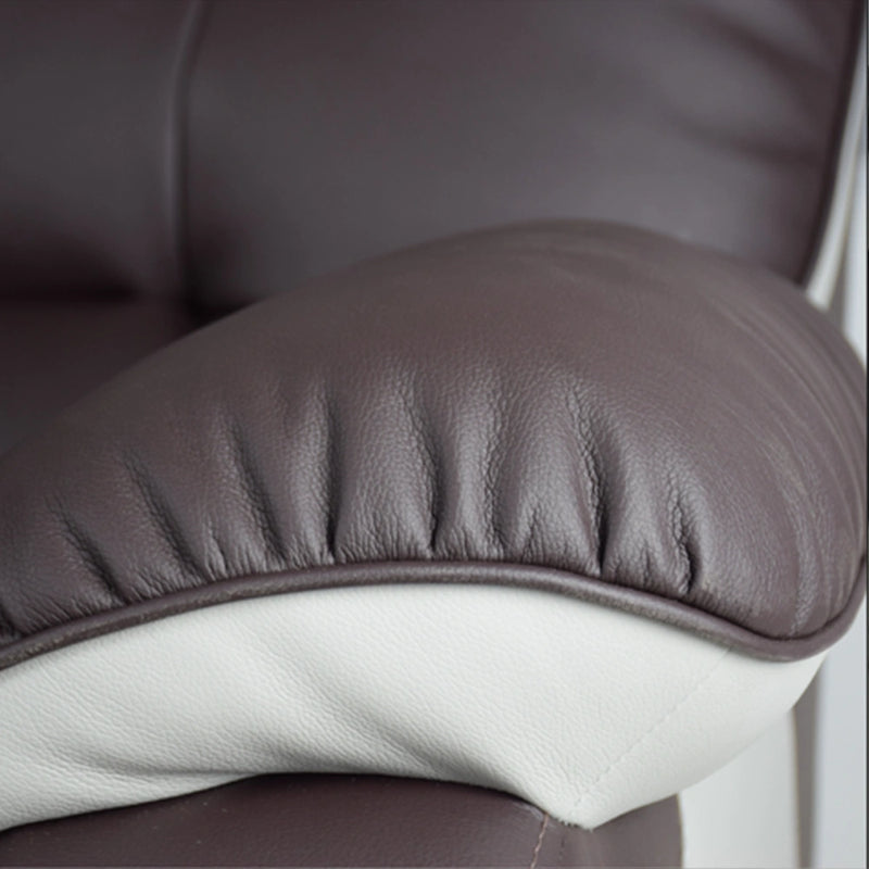 Close-up of a brown leather chair with a white cushion.