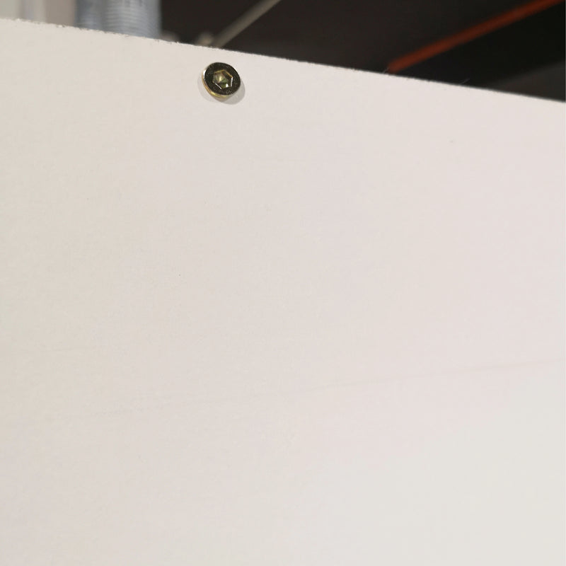Small metallic button on a white surface