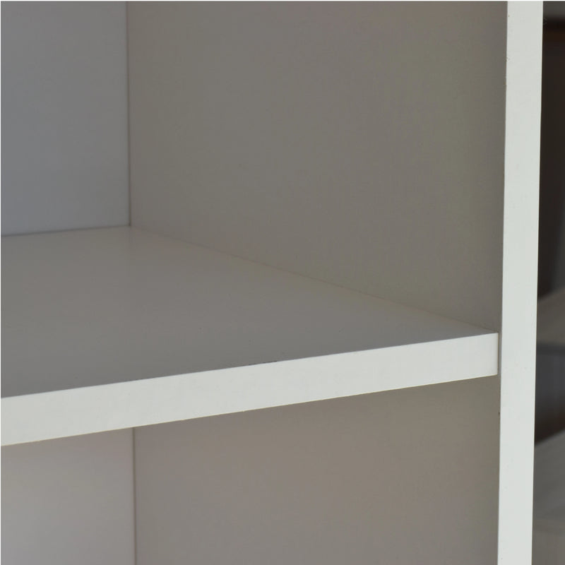 Corner of a white shelving unit with a neutral background