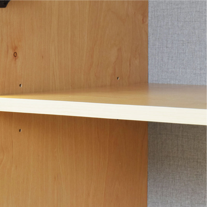 Wooden shelf with a textured gray wall in the background
