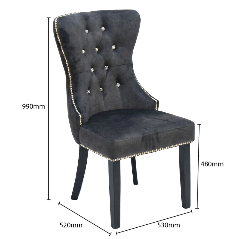 Gray upholstered chair with decorative buttons and measurements on a white background