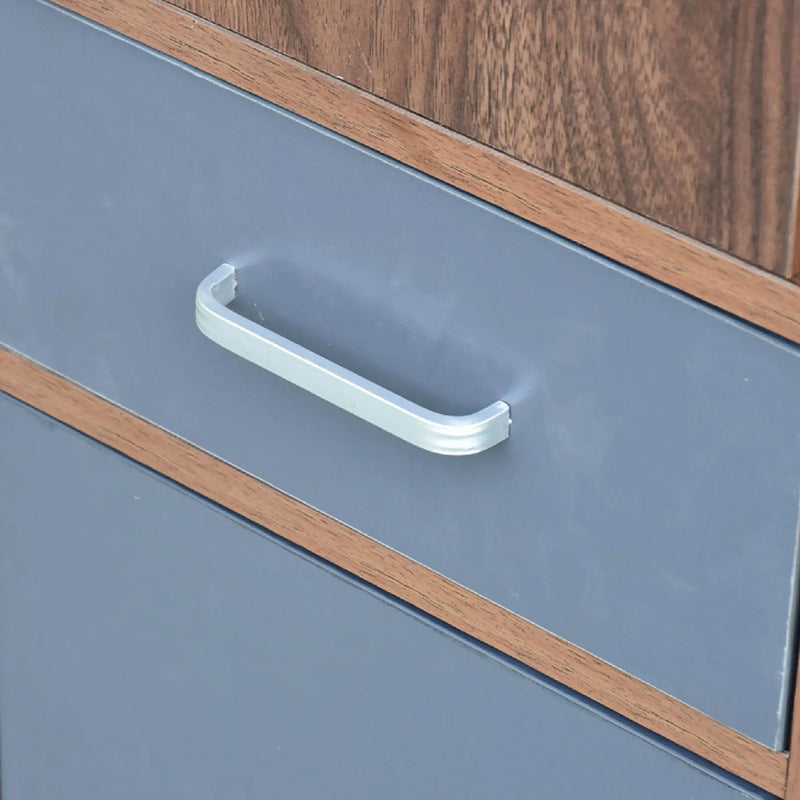 Close-up of a cabinet handle on a blue cabinet with wooden trim.
