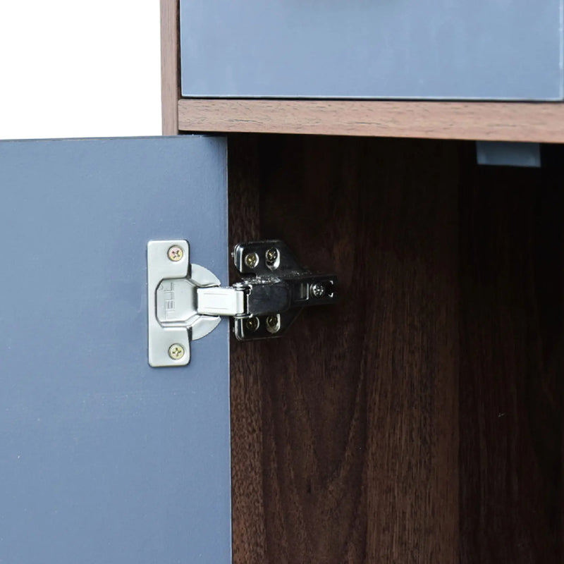 Close-up of a cabinet hinge on a wooden cabinet with blue doors.