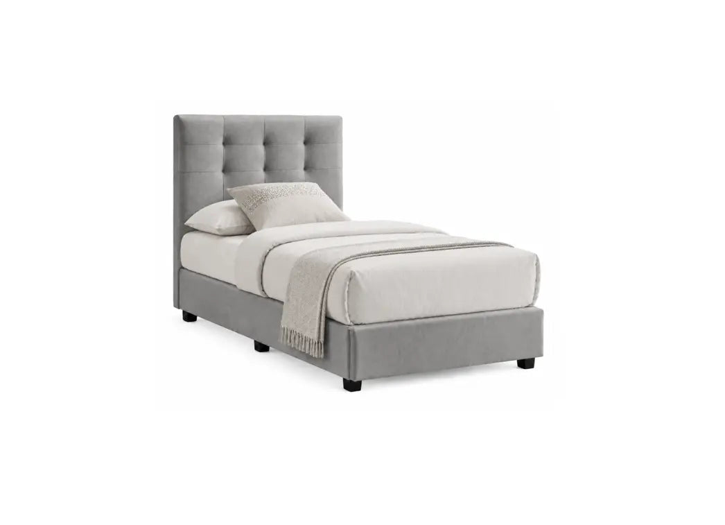 A single bed with a tall, tufted gray upholstered headboard and matching gray base, dressed in white bedding and a light gray throw blanket, shown on a plain white background.