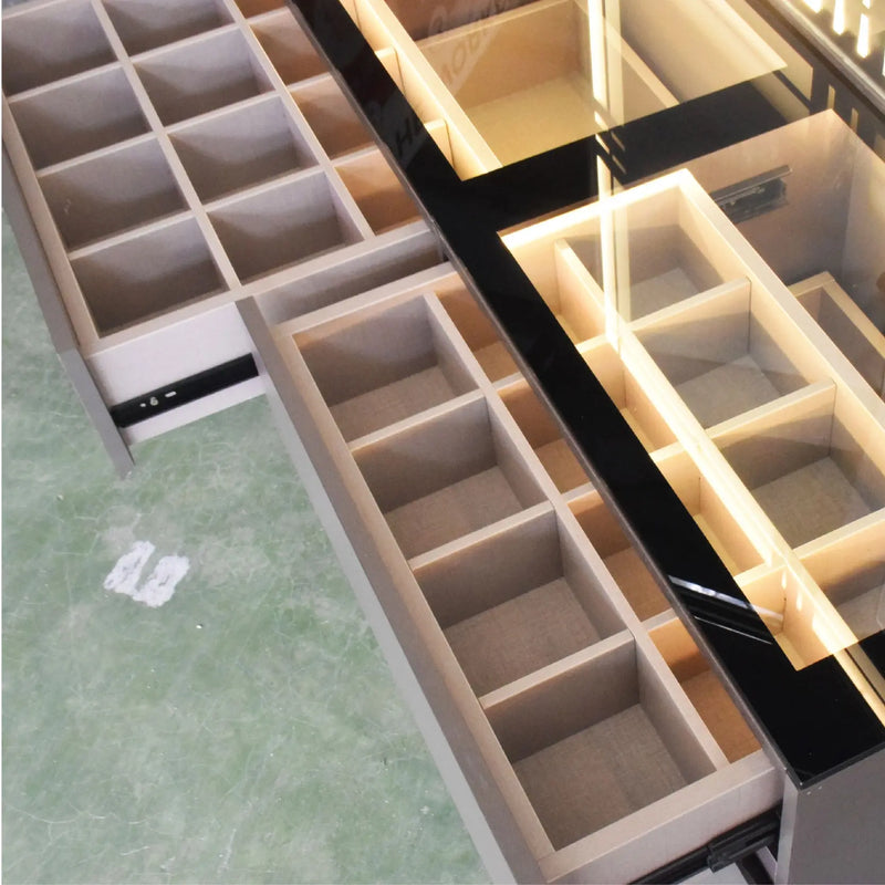 Wooden jewelry box with multiple compartments on a green marble surface