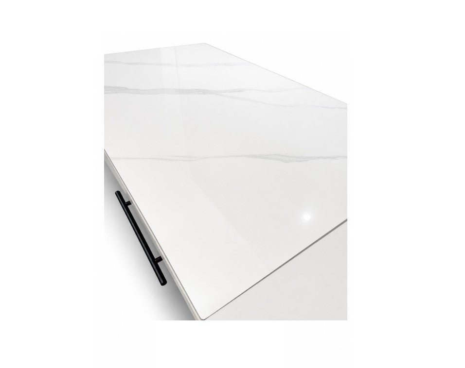 A glossy white rectangular tabletop or cabinet top with subtle gray marble veining, shown at an angle with a black drawer handle visible on the left side against