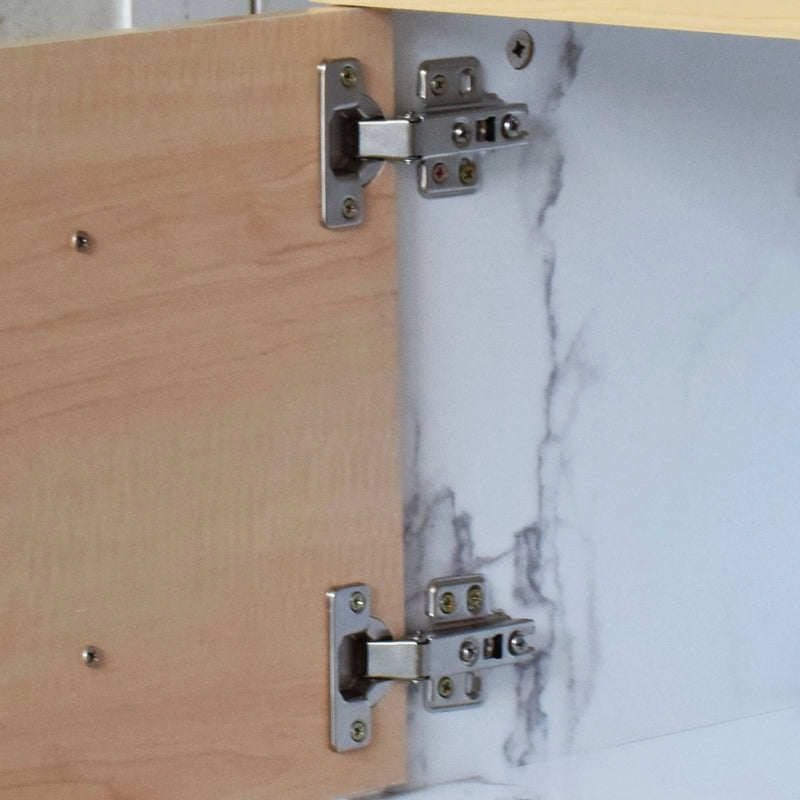 Close-up of a cabinet hinge on a wooden and marble-patterned surface