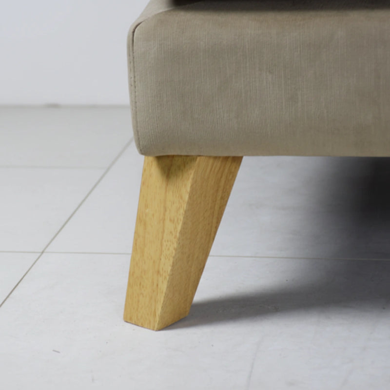 Close-up of a beige upholstered chair with wooden legs on a light gray floor.