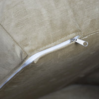 Close-up of a zipper on a beige fabric surface