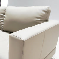 Beige leather sofa with a pillow