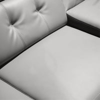Gray leather sectional sofa with tufted backrest