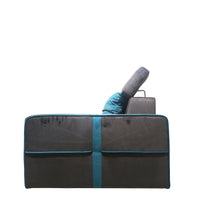 Gray and black car seat cover with blue trim on a white background