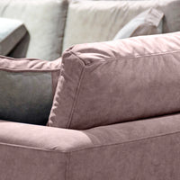 Close-up of a pink sofa with a focus on texture and color.
