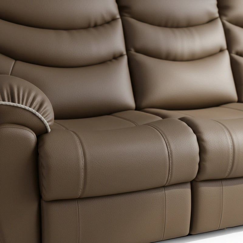 Close-up of a brown leather sofa with tufted backrests.