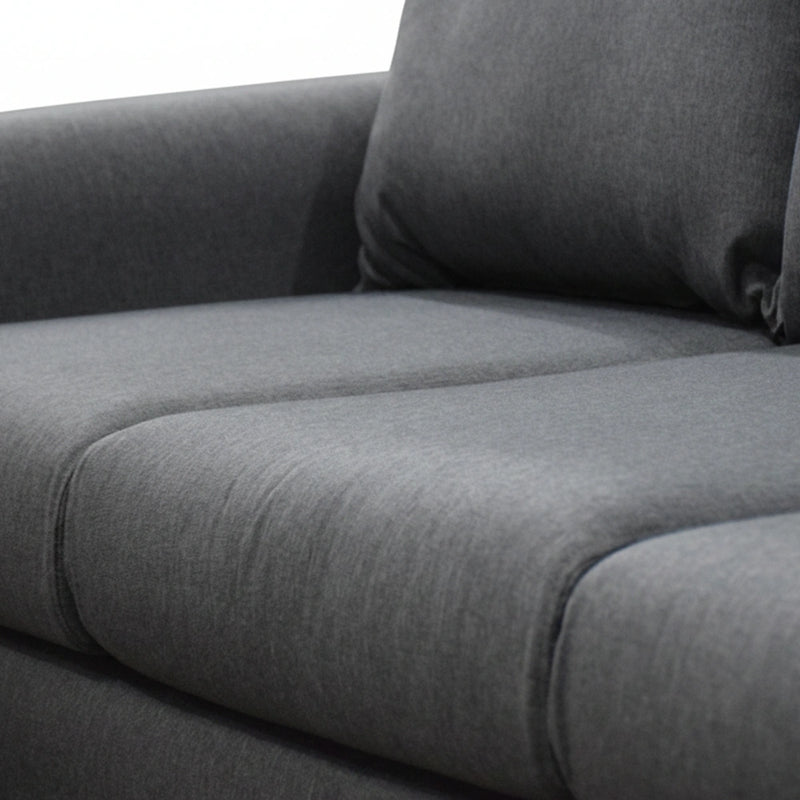 Gray fabric sofa with a pillow on a white background