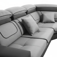 Gray sectional sofa with cushions on a white background