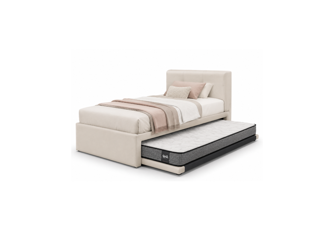 A modern single bed with an upholstered cream headboard and footboard, shown with a mattress pulled out into a trundle. The bed is styled with neutral beige and white bedding, set against a plain white background.
