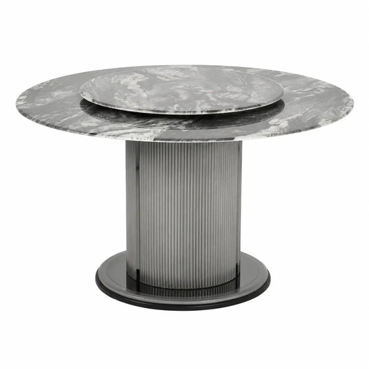 A modern round dining table featuring a gray and white marble top with a matching inset plate, supported by a ribbed metallic column on a circular base.