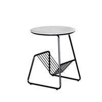 Small round table with a white top and black metal frame on a white background