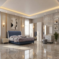 Modern bedroom with a blue bed, marble floor, and decorative wall art.