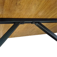 Close-up of a wooden table with black metal legs on a white background