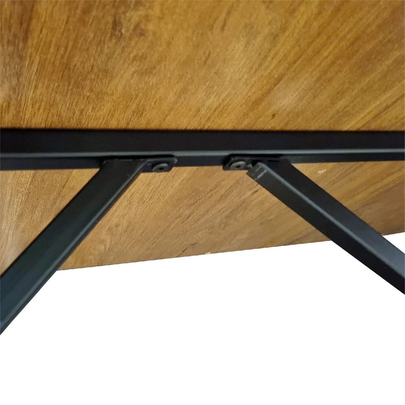 Close-up of a wooden table with black metal legs on a white background