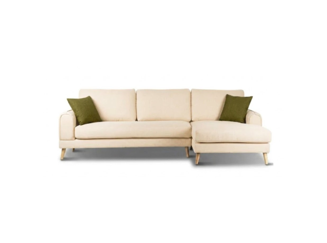 A modern three-seater sofa in a warm cream fabric with two olive green accent pillows and light wood legs, shown against a plain white background.