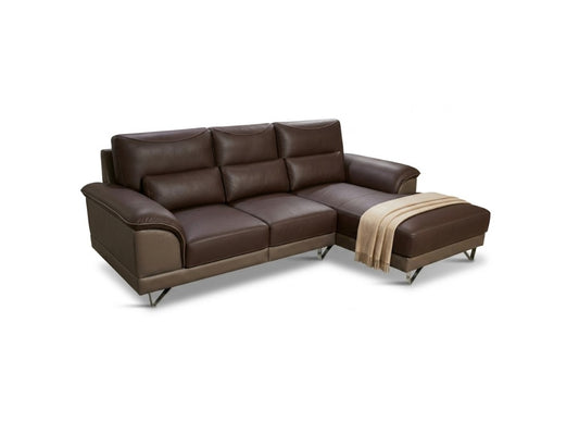 A dark brown leather sectional sofa with a chaise ottoman, featuring a draped beige throw blanket and slim metal legs, shown against a plain white background.