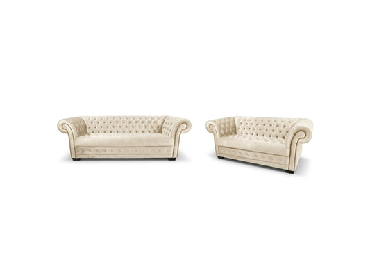 A matching set of two tufted armchairs in cream-colored upholstery, shown against a plain white background.