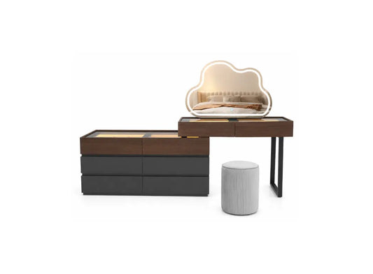 A modern bedroom furniture set featuring a dark brown and black storage cabinet, a matching wooden vanity desk with a cloud-shaped illuminated mirror, and a ribbed light gray cylindrical ottoman, shown on a solid white background.