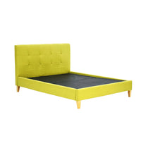 Yellow upholstered bed with tufted headboard on a white background