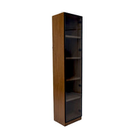 Tall wooden bookshelf with glass doors on a white background