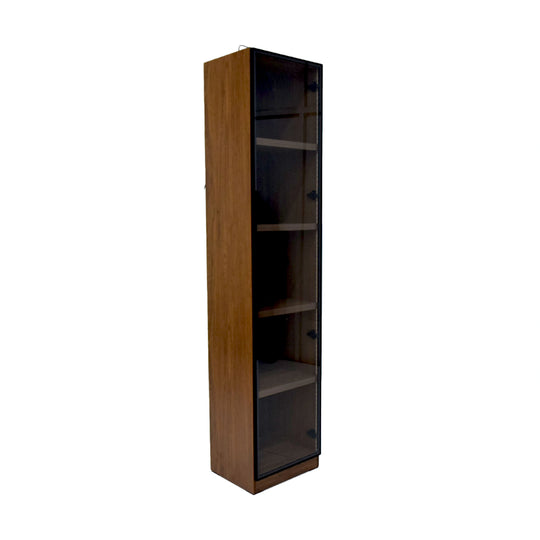 Tall wooden bookshelf with glass doors on a white background