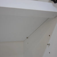 Close-up of a white ceiling with visible screws and a light fixture.