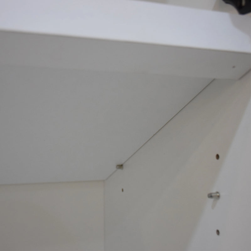 Close-up of a white ceiling with visible screws and a light fixture.