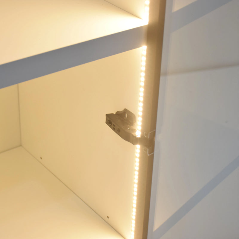 Close-up of a light fixture inside a cabinet with LED strip lighting.