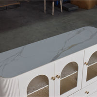 Modern white cabinet with marble-like top and glass panels in a room setting.