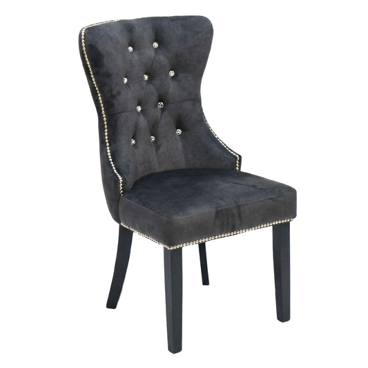 Gray upholstered chair with decorative buttons on a white background