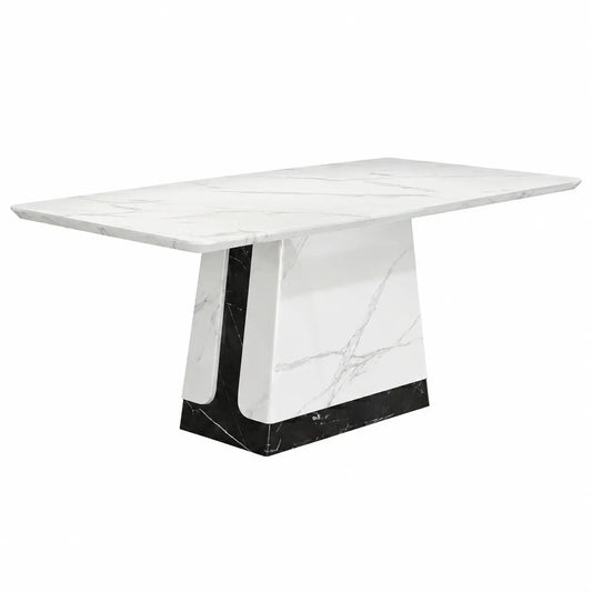 A modern rectangular dining table featuring a white marble top with gray veining and a sculptural pedestal base made of white marble with a black marble base.