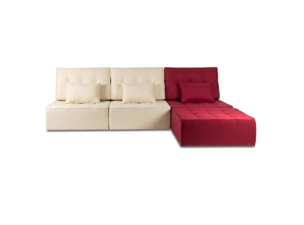 A modern modular sectional sofa with a left section upholstered in cream fabric and a right section in deep red, featuring matching accent pillows, shown against a plain white background.