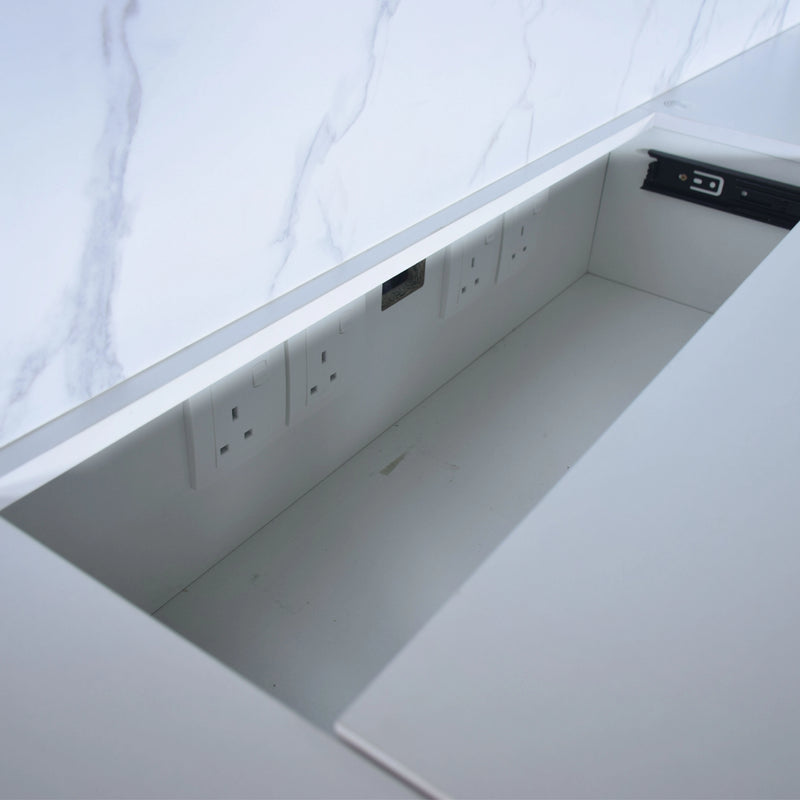 Underbed storage compartment with electrical outlets on a white bed frame.