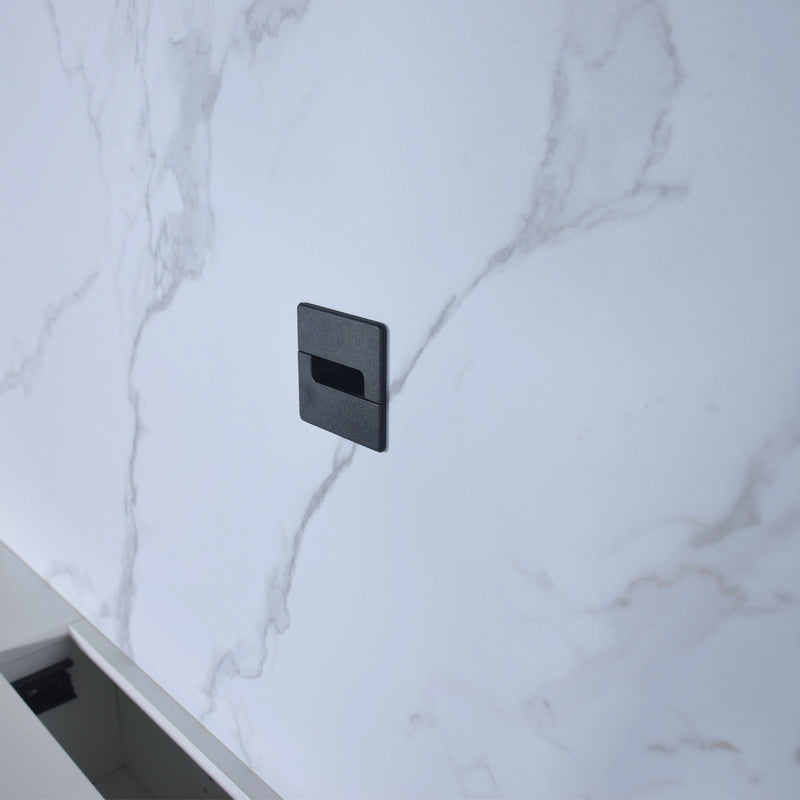 Black rectangular object on a marble surface